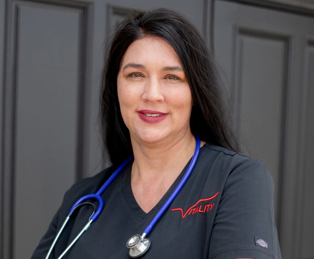 Dr. Thomas wearing black scrubs and stethoscope looped around her neck