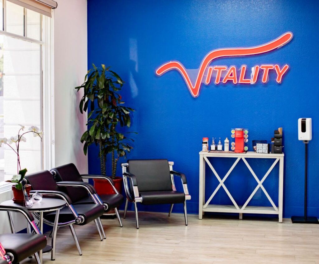 vitality wall signage in red against a blue background