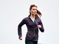 woman running wearing earpiece